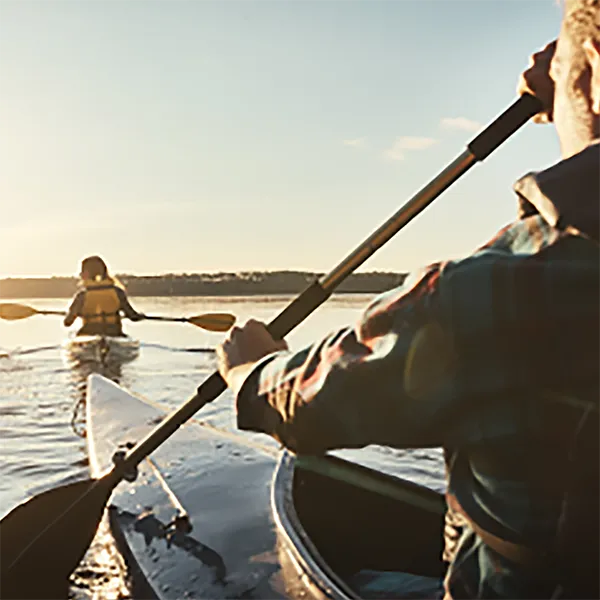 Two people kayaking on a lake.
