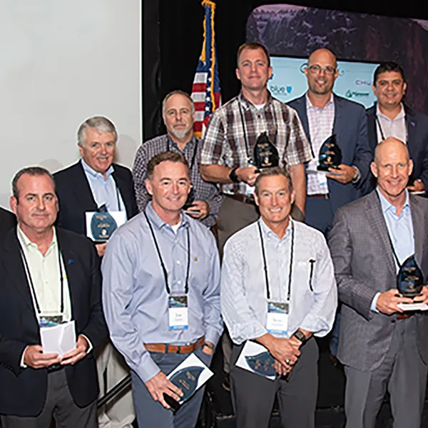 A group of InterWest team members holding awards.