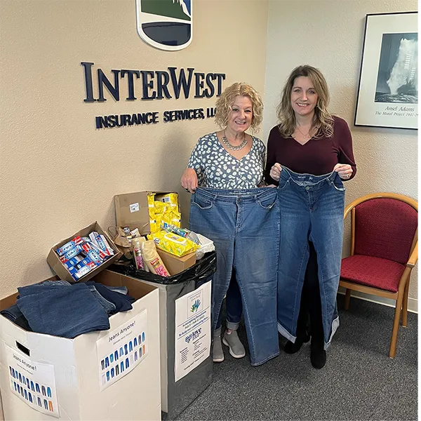 Two team members from the InterWest Merced Office with donations for those affected by flooding.