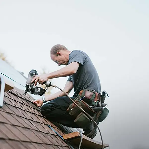 Contractors repairing a roof.