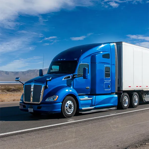 A semi truck with a blue cab on the highway.