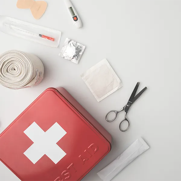The supplies from a first aid kit on a white background.
