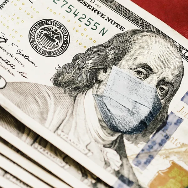 A stack of $100 bills with Ben Franklin wearing a surgical mask.