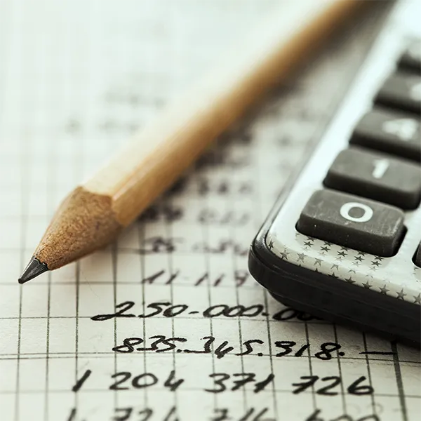 Close-up of a calculator and a pencil.