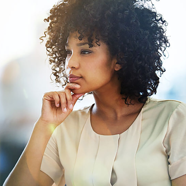 A businesswoman looking pensively at her computer.