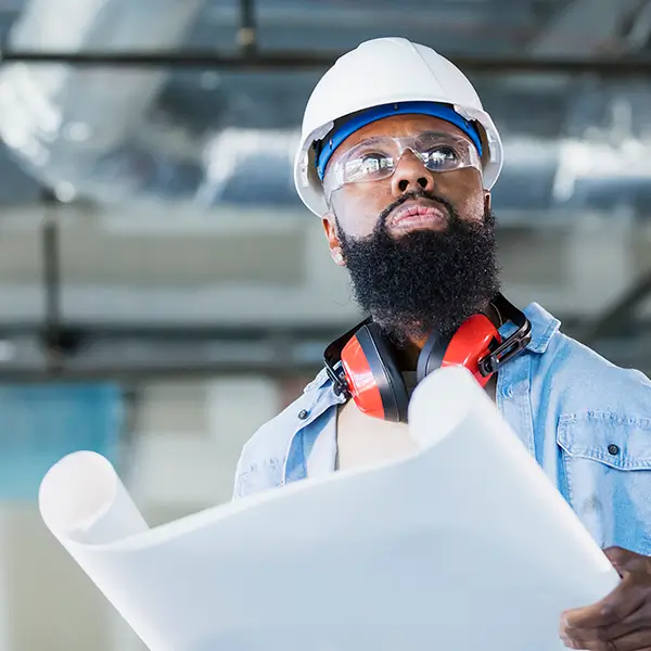 A contractor reviewing a set of blueprints.