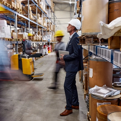 manager standing and observing workers