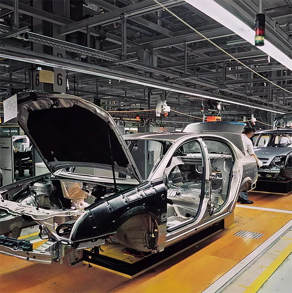 The frame of a car being built in a factory.