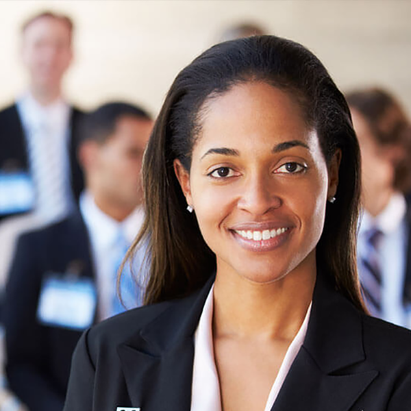 A group of professionals wearing suits and name badges.
