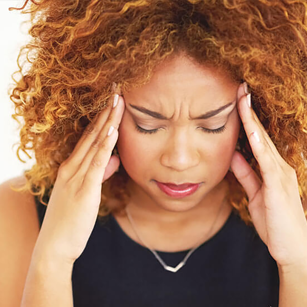 A homeowner holding her head in frustration.