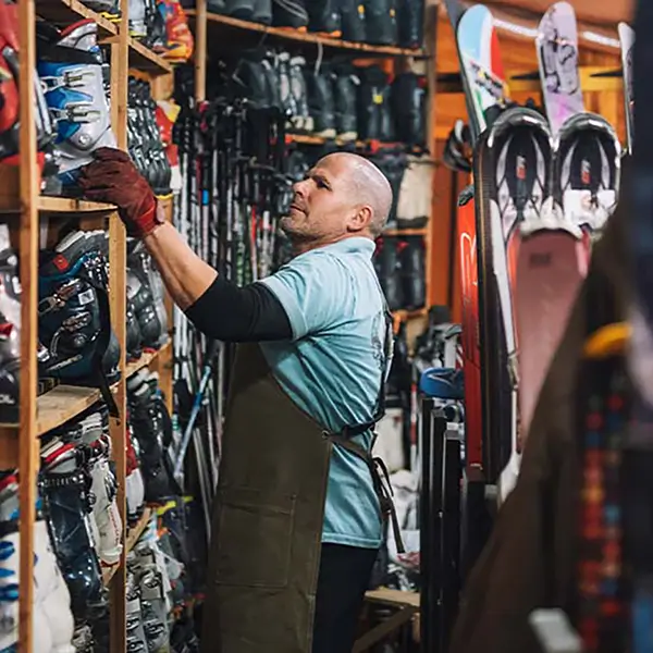 A ski shop owner reviewing inventory.