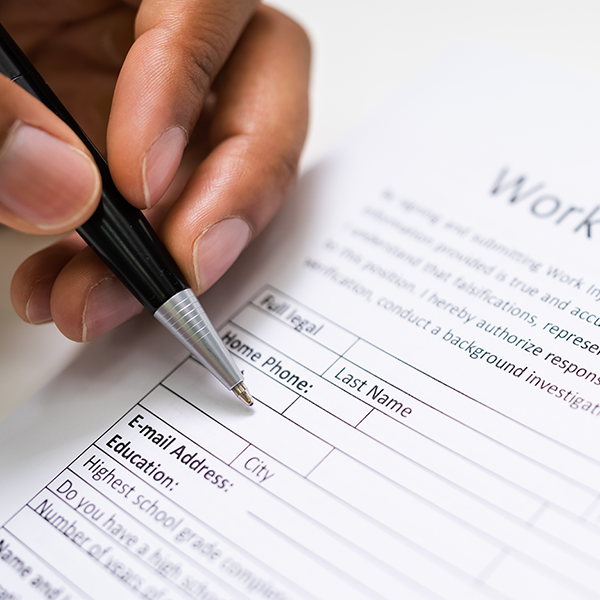 Someone filling out a work injury claim form.