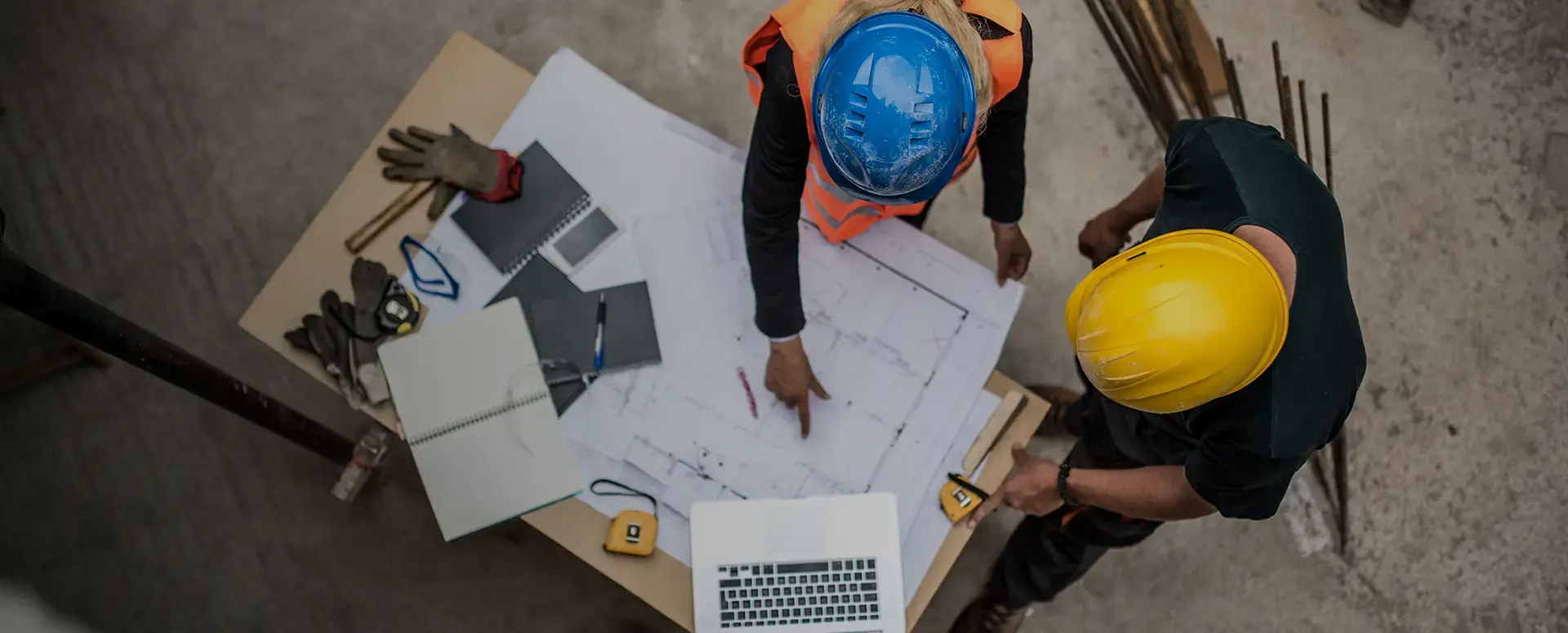 people in a hardhats looking at blueprints