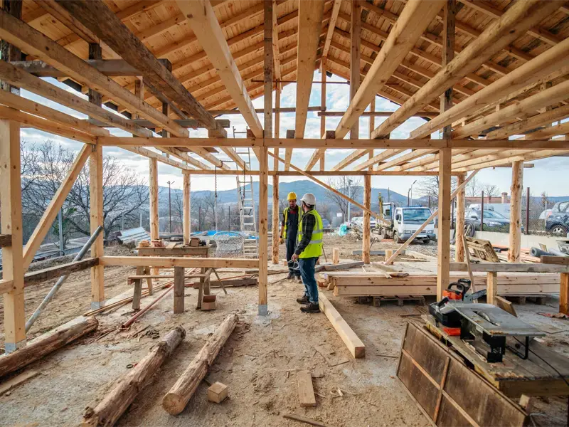 A construction work site with tow workers in safety gear.