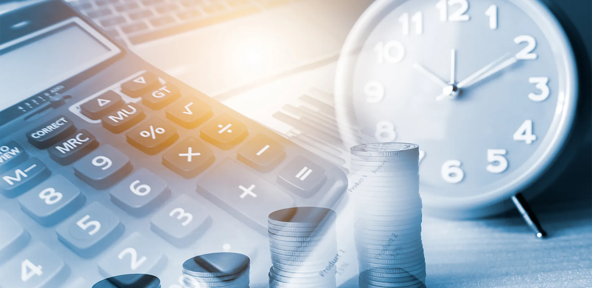 A calculator, an alarm clock, and stacks of coins.