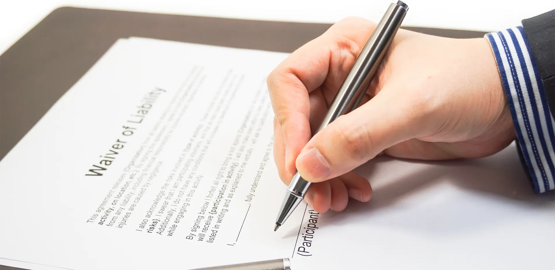 Someone signing a waiver of liability.