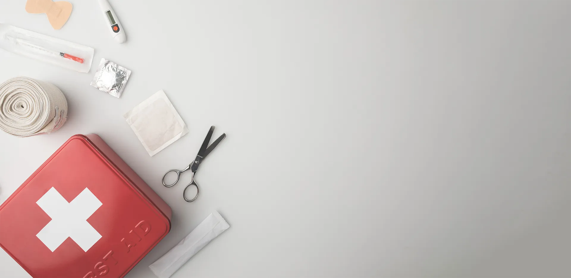 The supplies from a first aid kit on a white background.