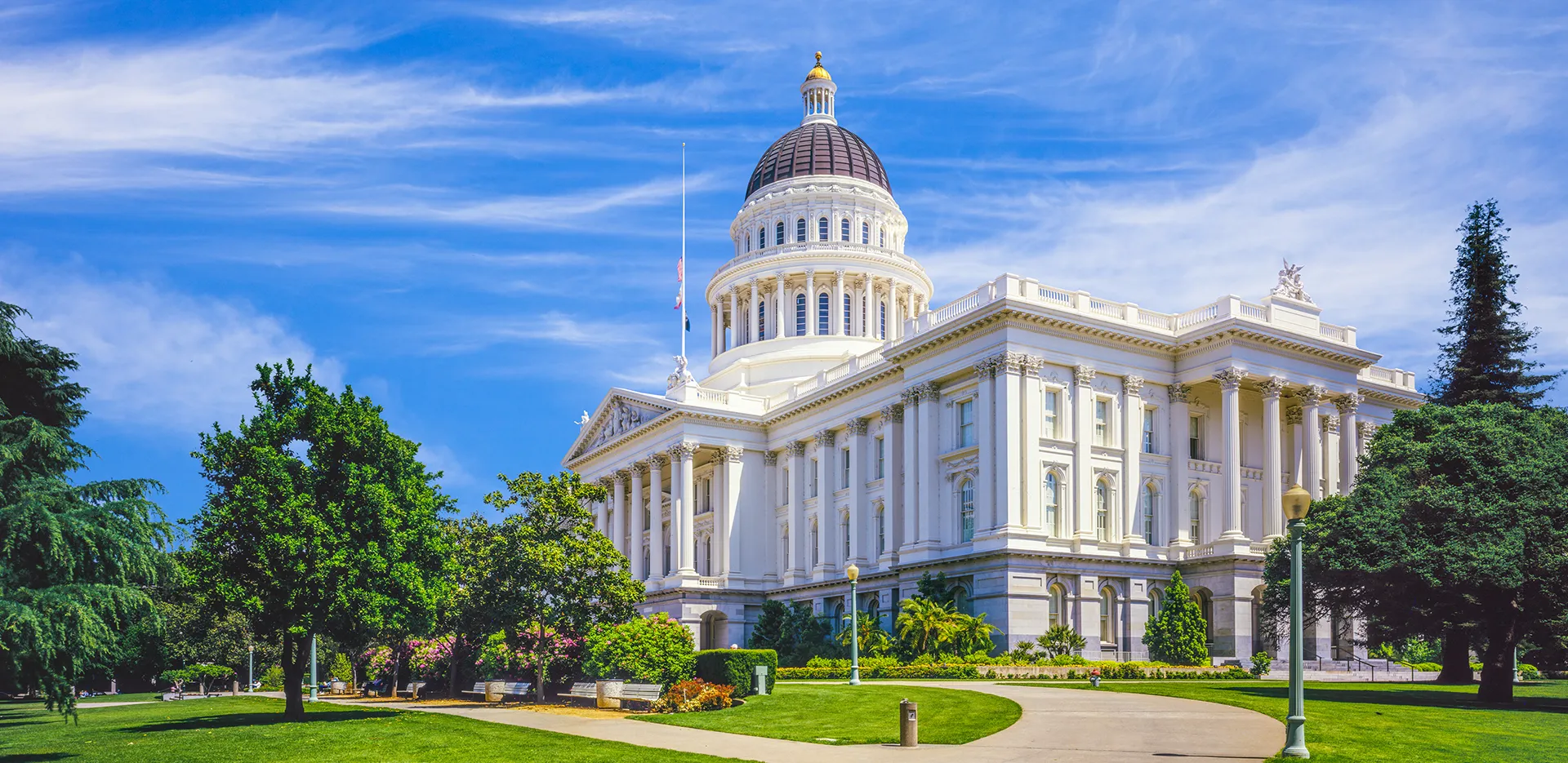 A photo of the California State Capitol building taken at an angle on a bright sunny day.