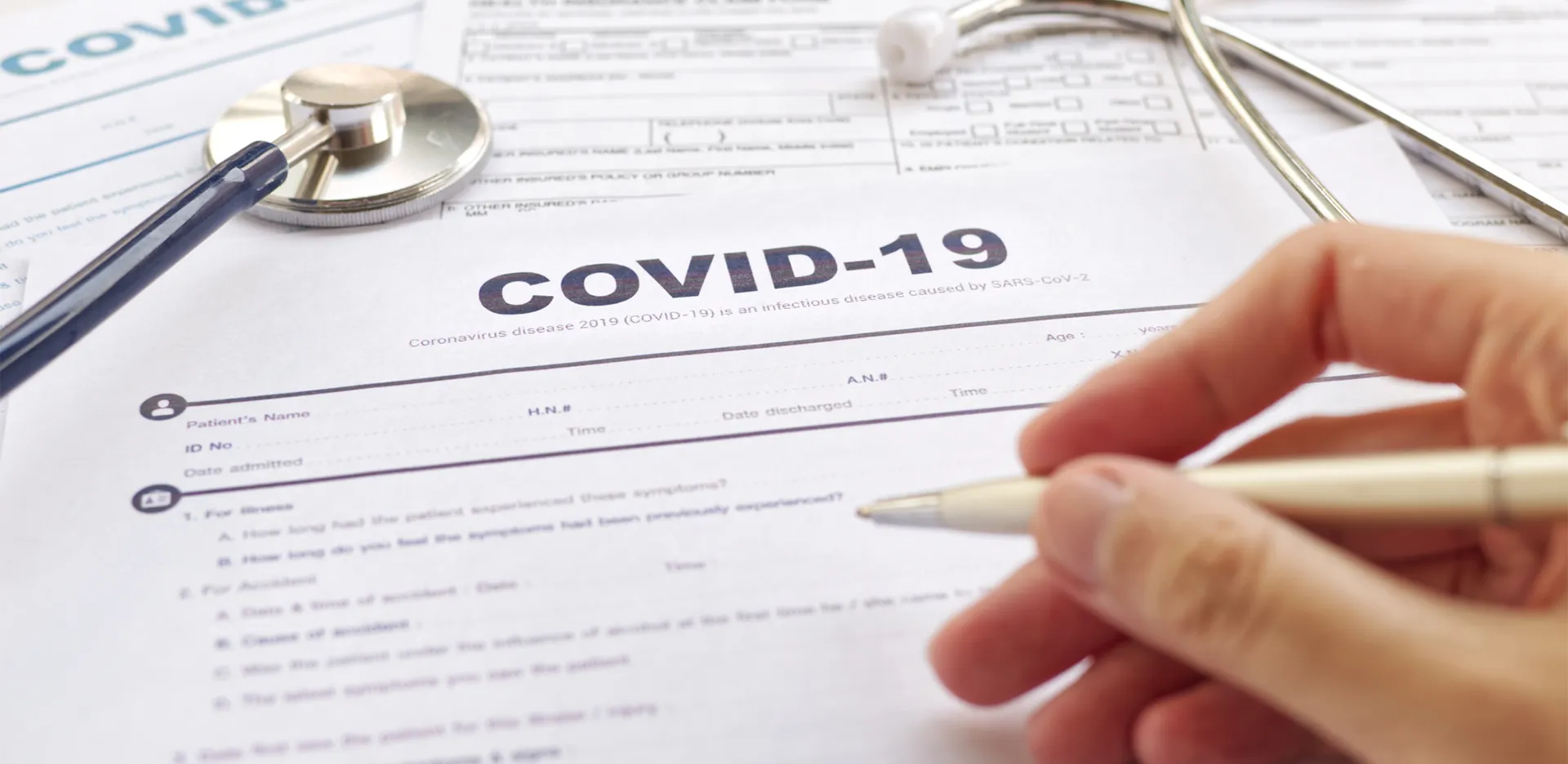 Someone filling out a form titled 'COVID-19.'
