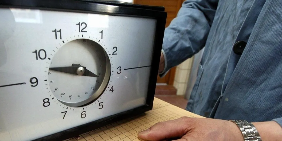 A wall clock being assessed in a repair shop