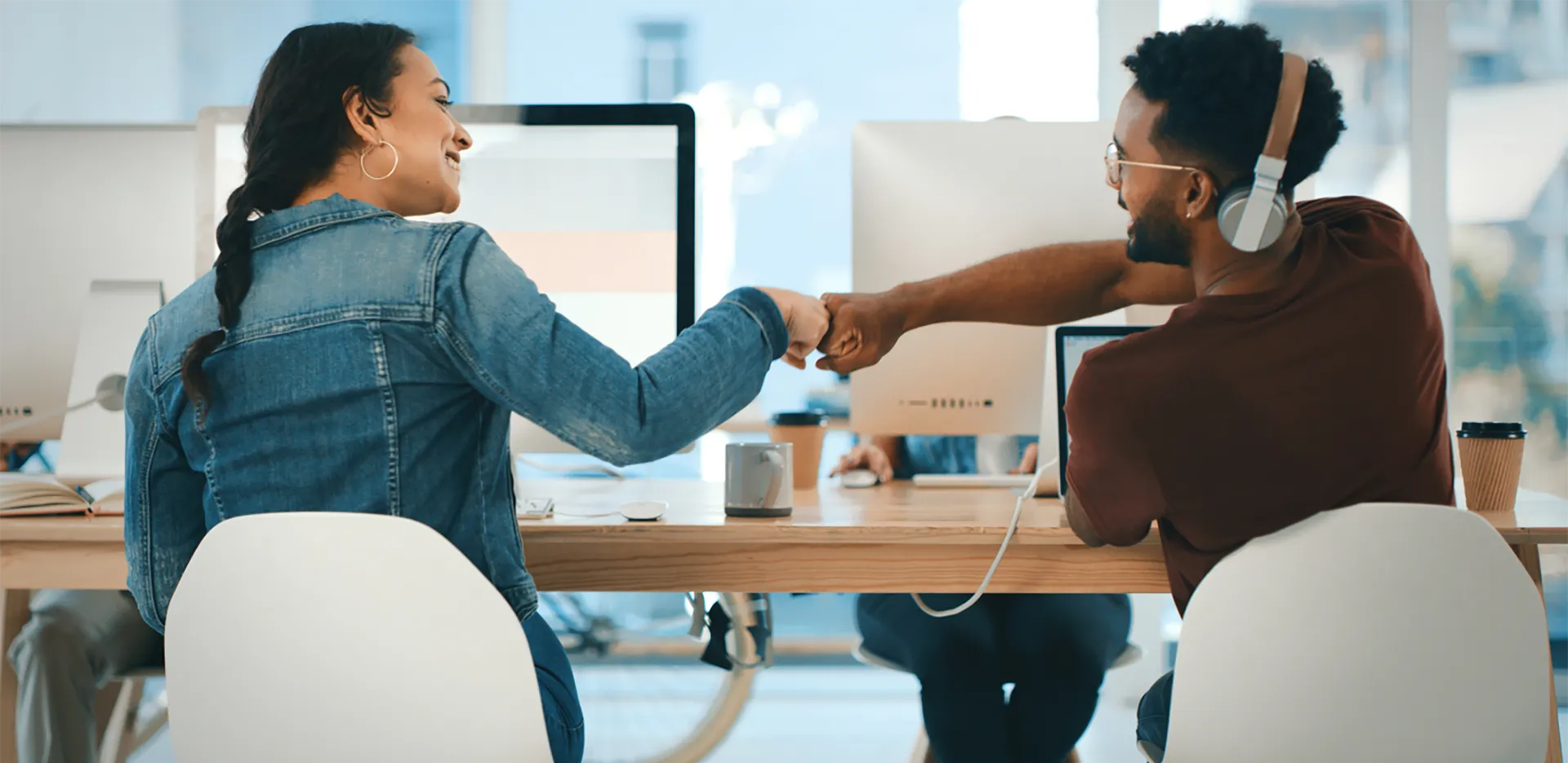 A pair of professionals fist bumping.