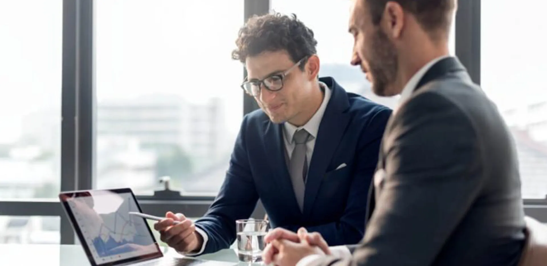 Two insurance professionals discussing a report.