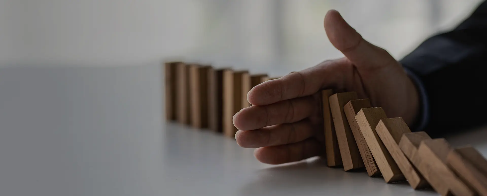 A group of students raising their hands in a classroom.