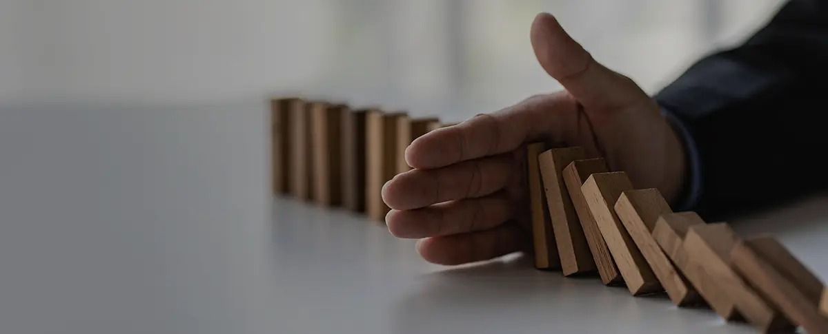 A group of students raising their hands in a classroom.