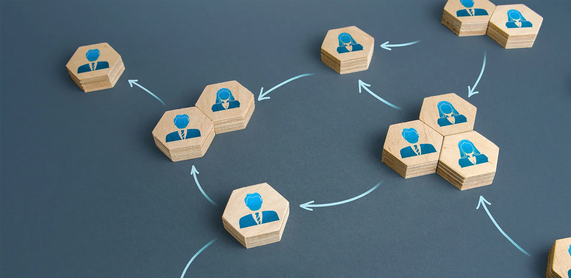 Hexagonal wood pieces with illustrations of office workers on them
