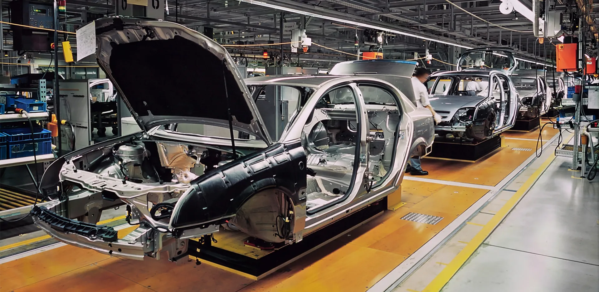 The frame of a car being built in a factory.