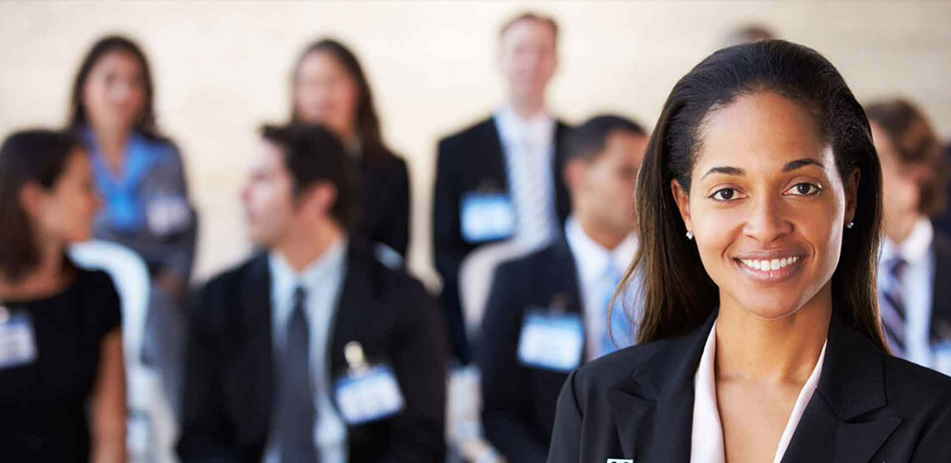 A group of professionals wearing suits and name badges.