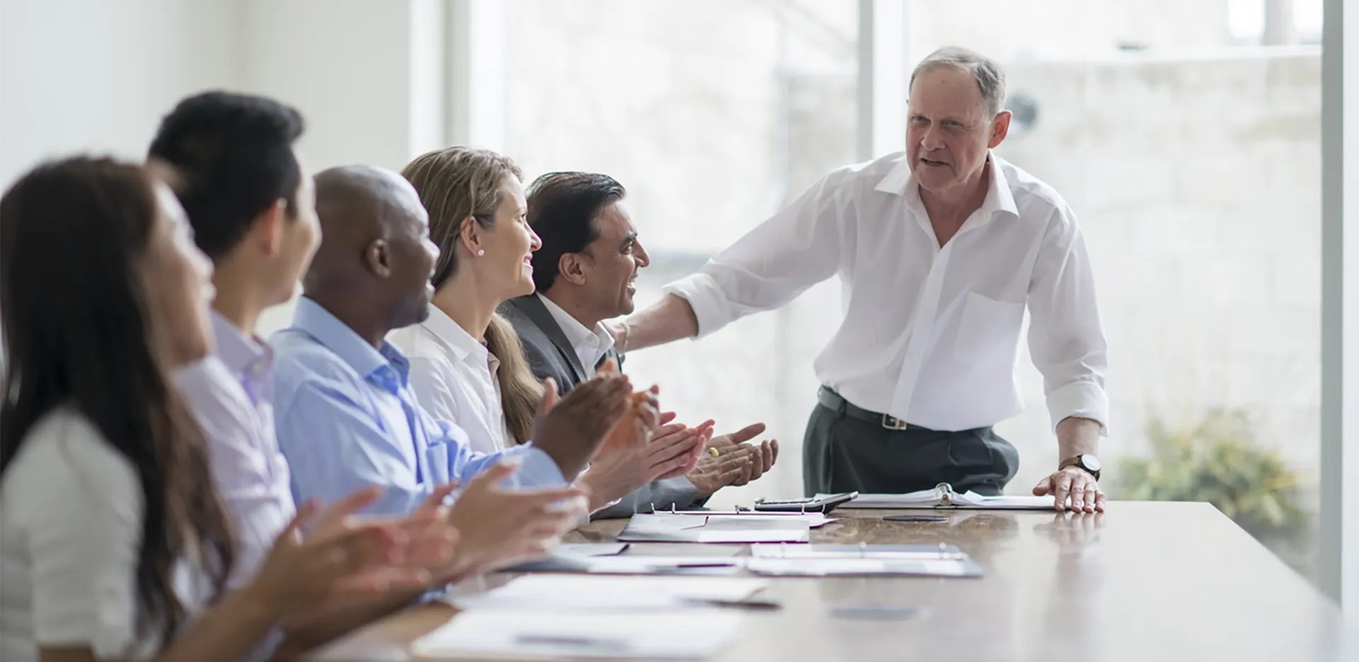 A leader giving a presentation to his team in a professional environment.