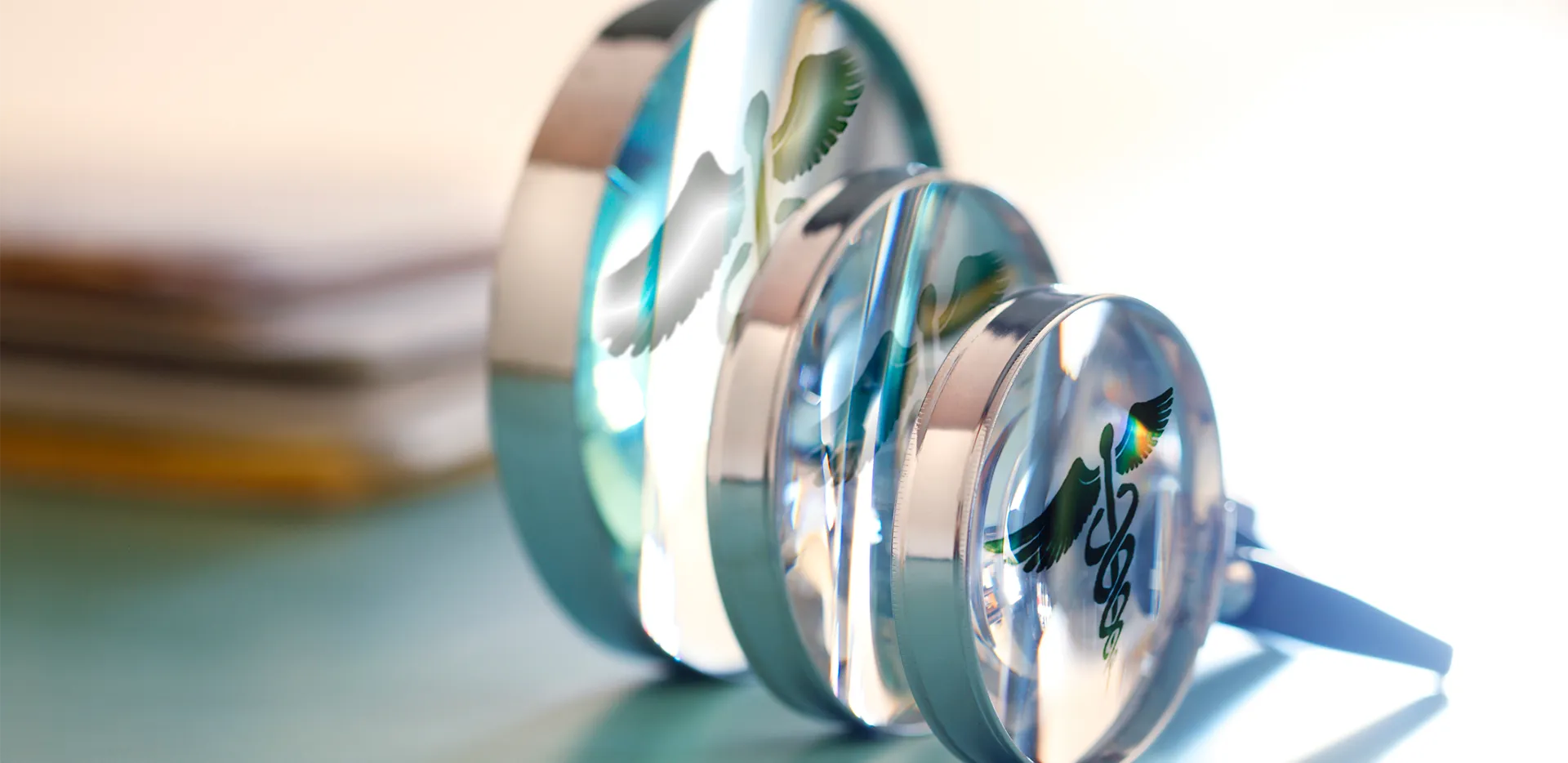A series of magnifying glasses showing a caduceus staff.