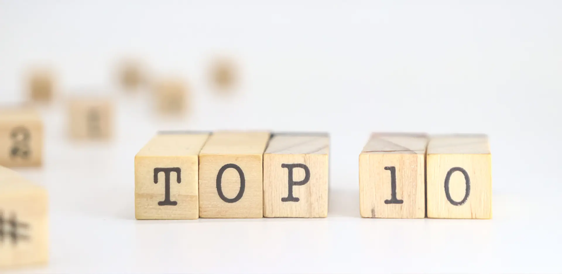Wooden blocks with letters printed on them lined up to read Top 10.