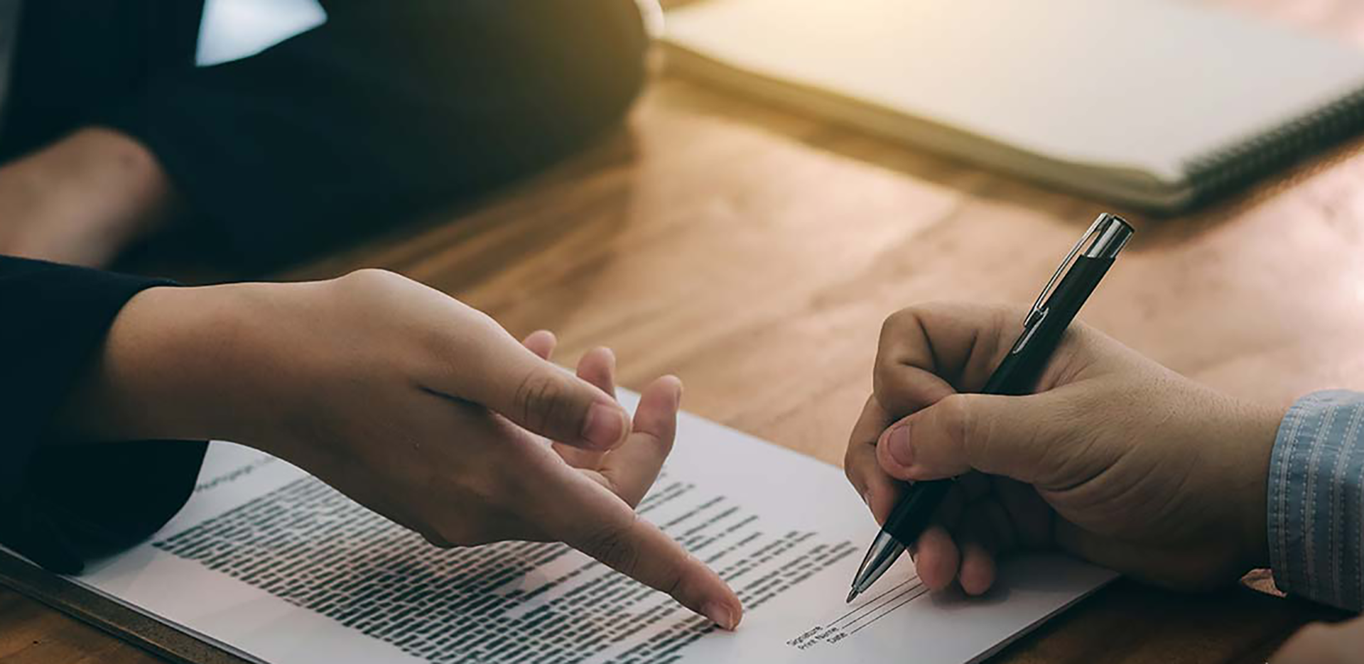 Two professionals reviewing insurance paperwork.