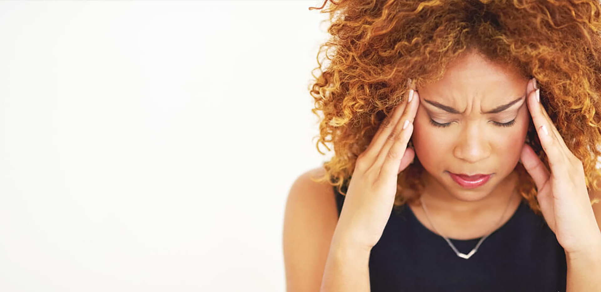 A homeowner holding her head in frustration.