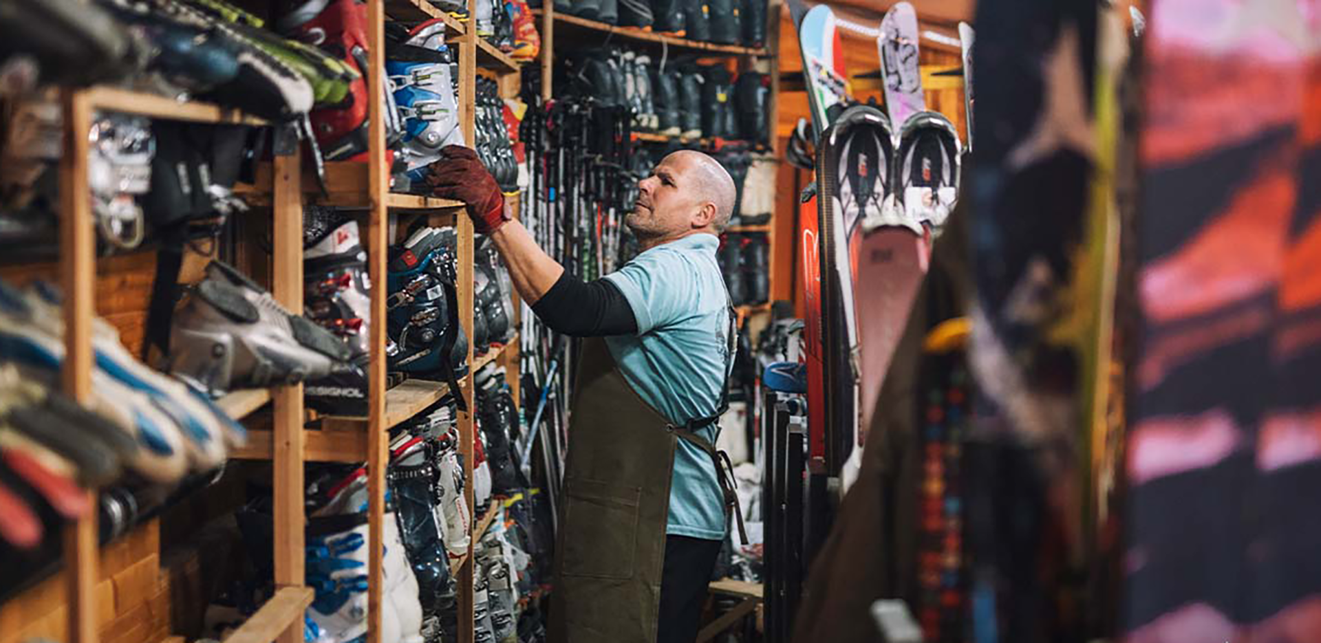 A ski shop owner reviewing inventory.