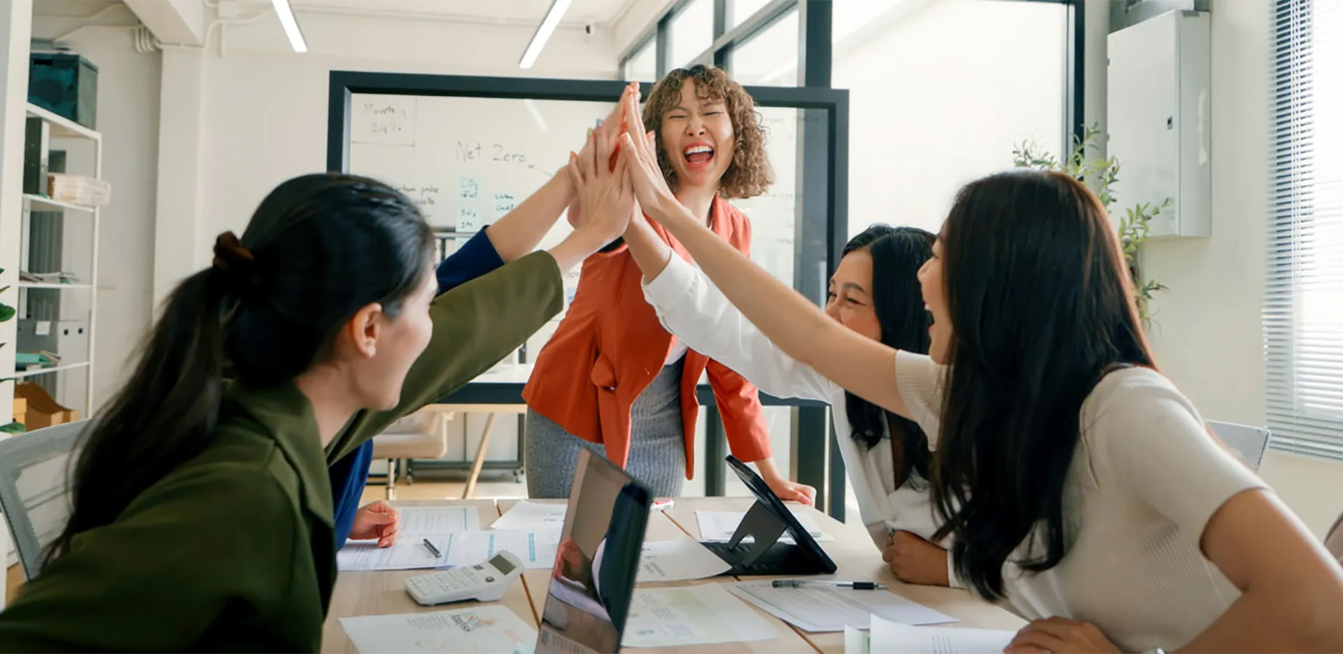 A group of professionals high fiving.