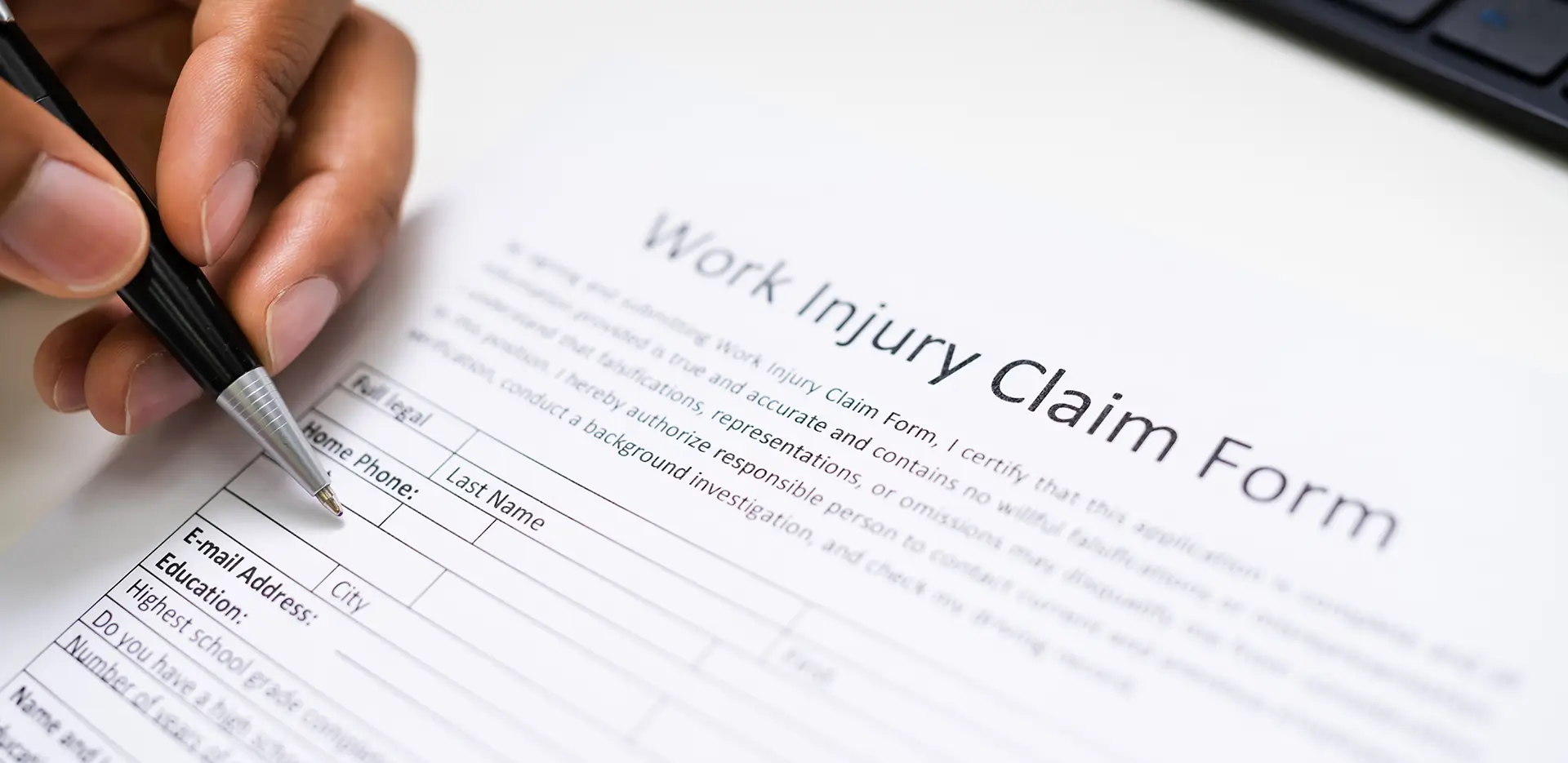 Someone filling out a work injury claim form.