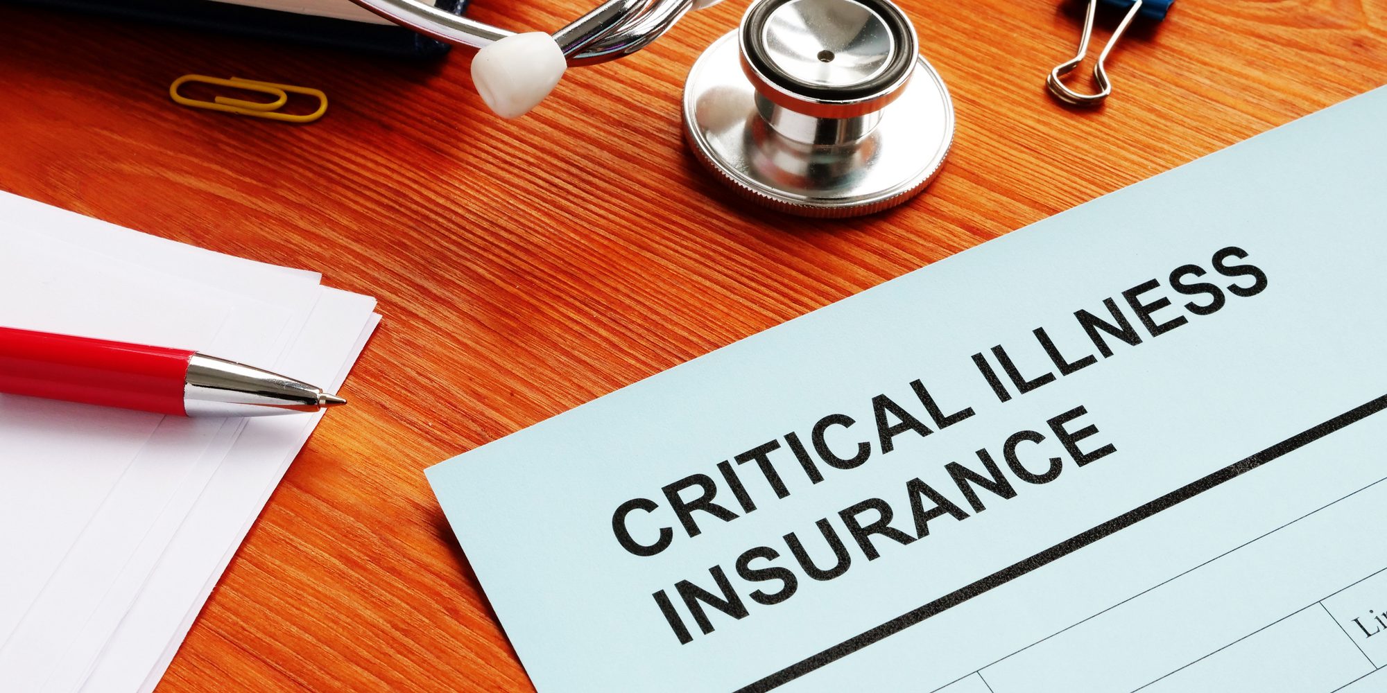 Critical Illness Insurance form and stethoscope.