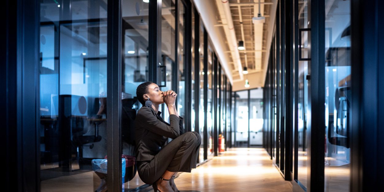 Worried young business woman at corridor office