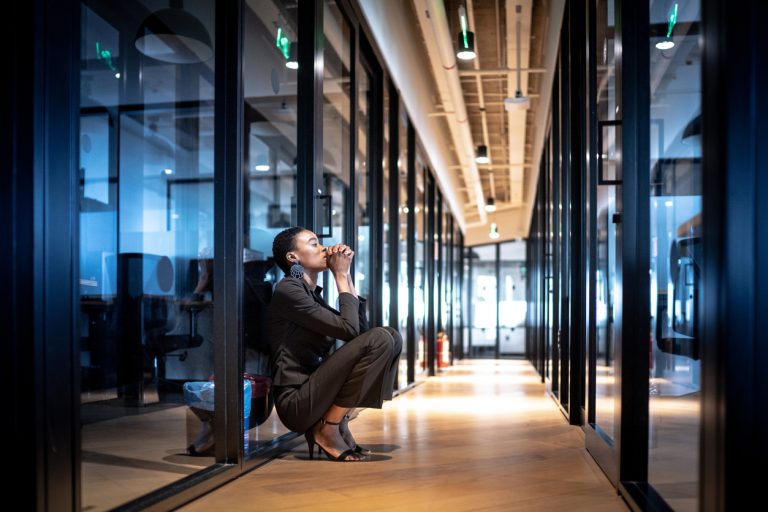 Worried young business woman at corridor office